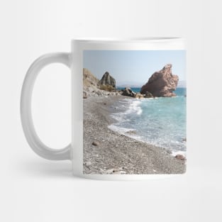 Shoreline with pebbles and blue water Mug